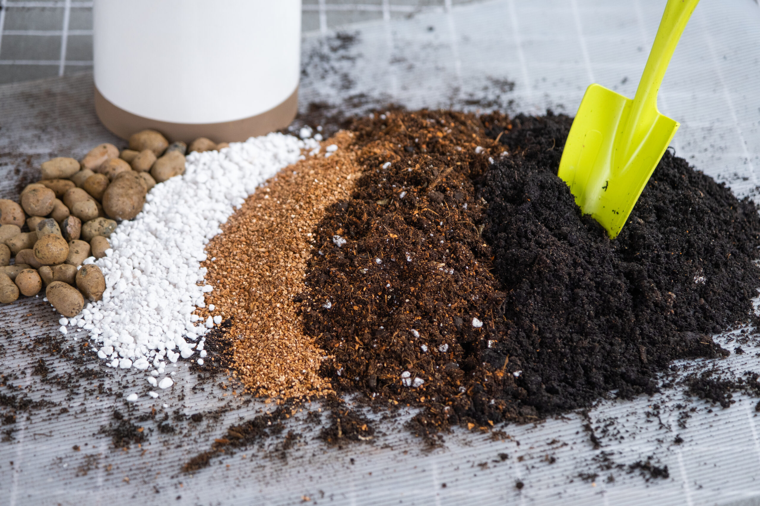 Ingredients for the soil of home potted plants, peat, earth, sand, perlite, vermiculite, coconut. A mixture for planting plants in a pot. Layout